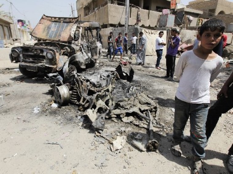 Residents gather at the site of a car bomb attack in the Kamaliya district in Baghdad April 15, 2013. Car bombs and attacks on cities across Iraq, including two blasts at a checkpoint at Baghdad international airport, killed at least 20 people and...