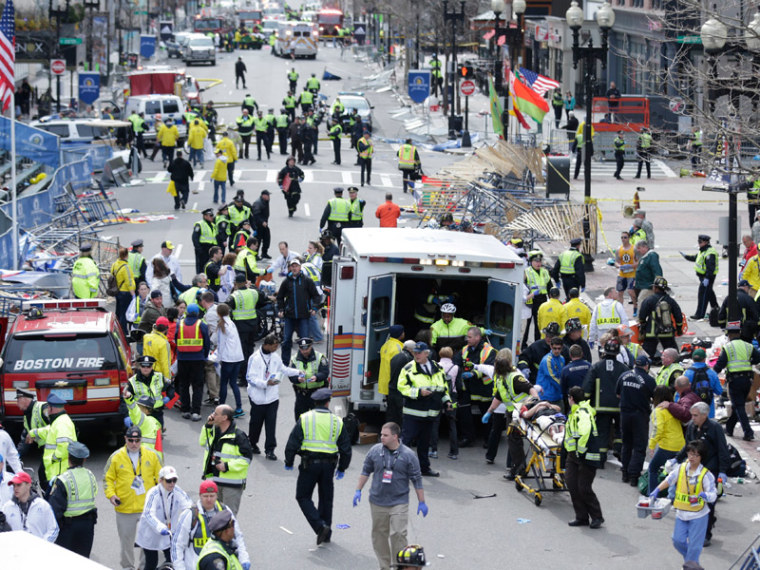 Medical workers aid injured people at the finish line of the 2013 Boston Marathon following an explosion in Boston on April 15, 2013. (Photo by Charles Krupa/AP Photo)