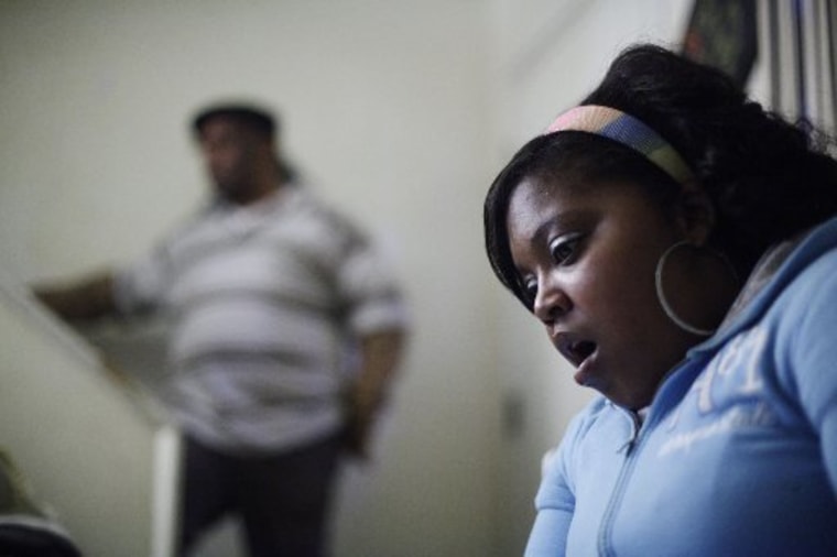 File Photo: Davida Johnson, 30, seen with her husband Bobby Johnson, reacts as she reads a grand jury report brought to her by the Associated Press during an interview in Philadelphia. Johnson believes she contracted a venereal disease while undergoing...