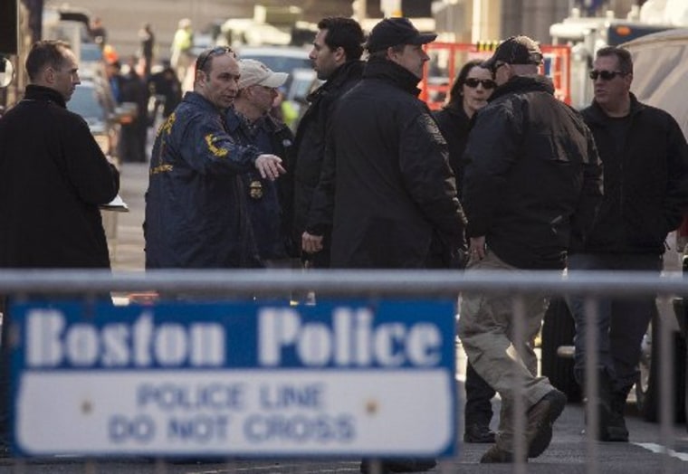 Security officials gather inside a police cordon a day after explosions hit the Boston Marathon in Boston, Massachusetts on April 16, 2013. Officials investigating the Boston Marathon bombing said on Tuesday that no additional explosive devices have...