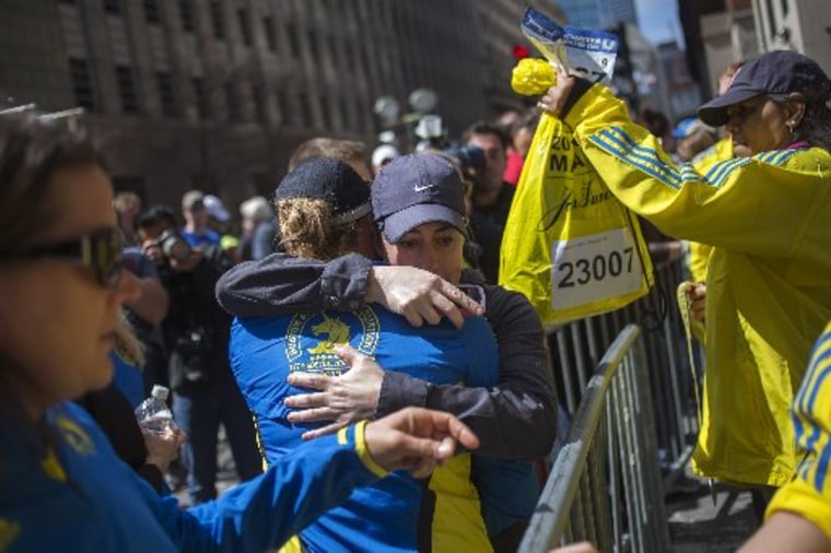 Runners embrace after picking up their medals near the finish line of the Boston Marathon REUTERS/Adrees Latif