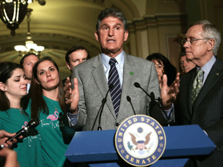 Standing alongside Senate Majority Leader Harry Reid and family members of Newtown victim, Sen. Joe Manchin speaks as  after a vote on the Senate floor April 17, 2013 in Washington, DC.  (Photo by Alex Wong/Getty Images)