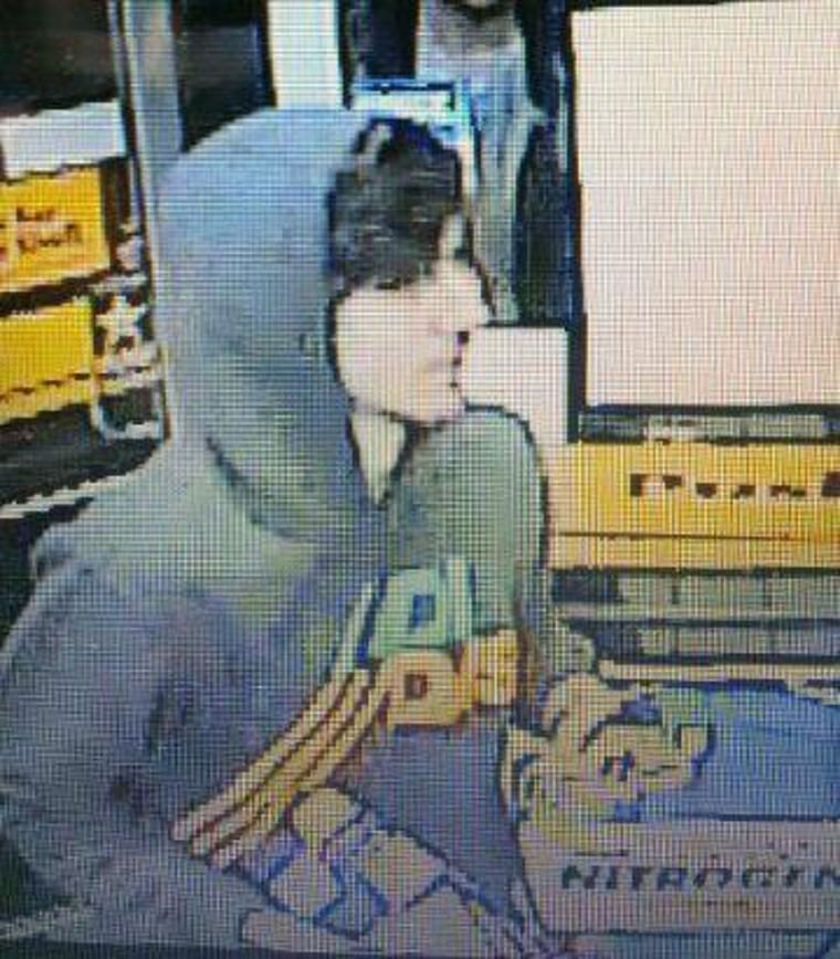 Boston police released this photograph of the Boston marathon bombing suspect at a 7-11 Thursday night. He is believed to be the man in the white hat in the photos FBI released Thursday afternoon.