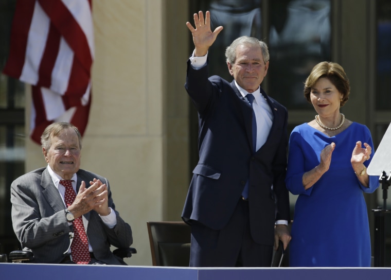 Former president George H.W. Bush, left, applauds with Laura Bush after former president George W. Bush's speech during the dedication of the George W. Bush Presidential Center Thursday, April 25, 2013, in Dallas. (AP Photo/David J. Phillip)