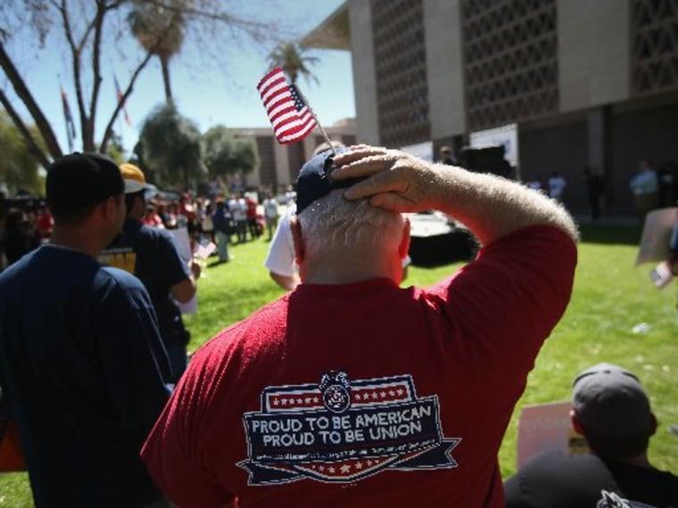 Arizona union supporters gather in support of comprehensive immigration reform outside the Arizona State Capitol building on March 11, 2013, in Phoenix. The rally, organized by the AFL-CIO, was the last of a national tour in support of immigration...
