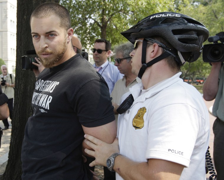 A Park Police officer, right, arrests Adam Kokesh of Iraq Veterans Against the War, Thursday, Sept. 6, 2006, in Lafayette Park across from the White House in Washington, after he put up anti-war posters. (AP Photo/Ron Edmonds)