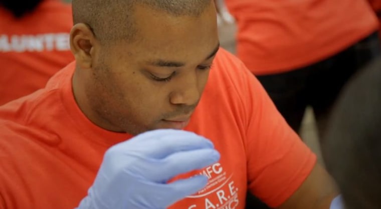A volunteer for the National Association of Free &amp; Charitable Clinics helps a patient. (Image via NAFC)