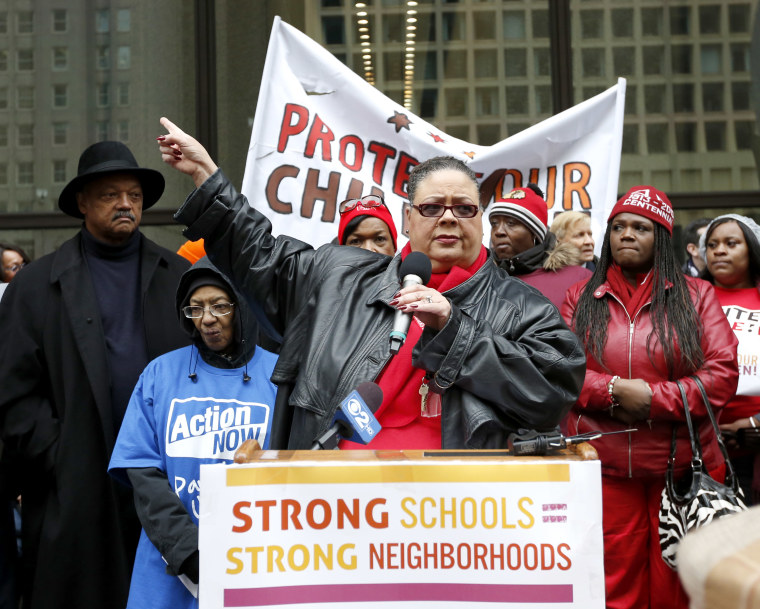 Karen Lewis, center, President of the Chicago Teachers Union addresses other opponents of a plan to close 54 Chicago Public Schools during a demonstration and march through Chicago's downtown Wednesday, March 27, 2013. (AP Photo/Charles Rex Arbogast)