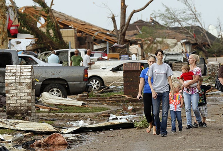 People walk through a neighborhood south of SW 149th between Western and Hudson after a tornado struck south Oklahoma City and Moore, Okla., Monday, May 20, 2013. (AP Photo/ The Oklahoman, Nate Billings)