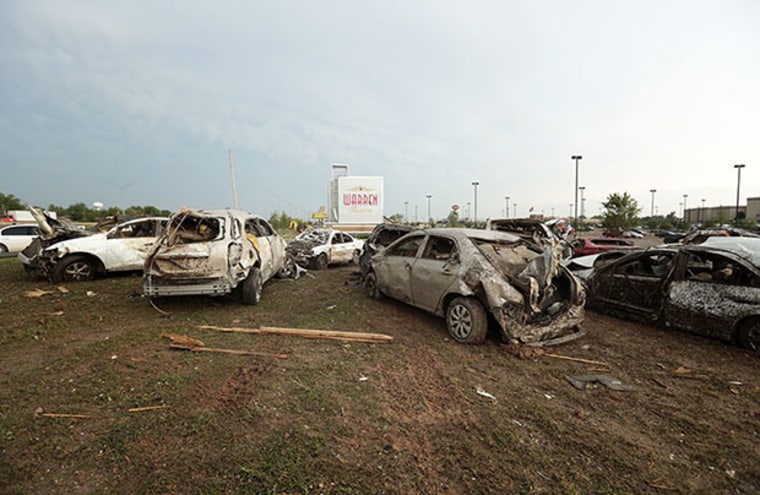 MOORE, OK- MAY 20:  Damaged vehicles are piled up in front of the Moore Warren Theater after a powerful tornado ripped through the area on May 20, 2013 in Moore, Oklahoma. The tornado, reported to be at least EF4 strength and two miles wide, touched...