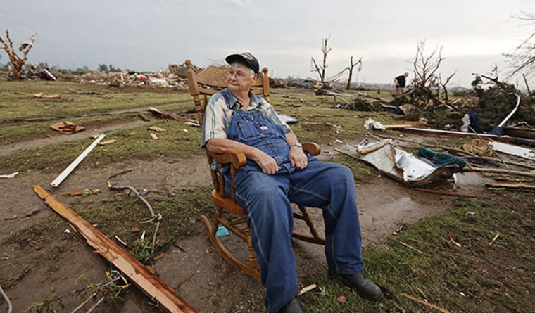 Gene Tripp sits in his rocking chair where his home once stood after being destroyed by a tornado hit the area near 149th and Drexel on Monday, May 20, 2013 in Oklahoma City, Okla.   (AP Photo/ The Oklahoman, Chris Landsberger)