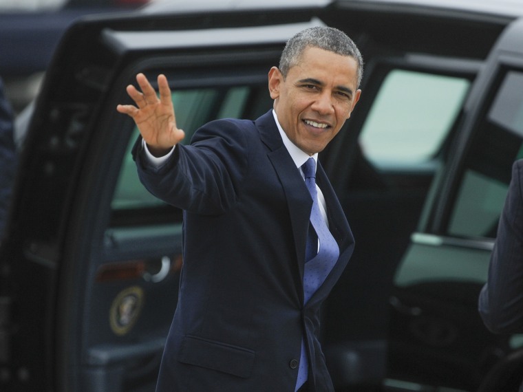 President Barack Obama waves to a crowd gathered at Hartsfield-Jackson International Airport on his way to give the commencement (AP Photo/John Amis)