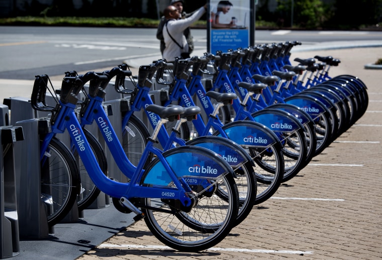 Bicycles, part of the NYC Bike Share program, are lined up at a dock and lock station at the Brooklyn Navy Yards Sunday, May 12, 2013 in New York. The expanding bike share system allows those who join to ride bicycles and return them from the same or...
