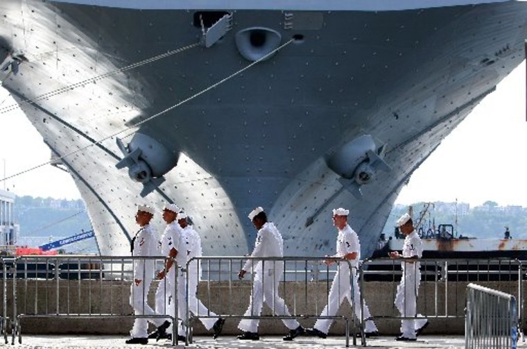 U.S. Navy sailors walk past the USS Iwo Jima docked on the Hudson River during Fleet Week May 22, 2009 in New York City. (Photo by Mario Tama/Getty Images)