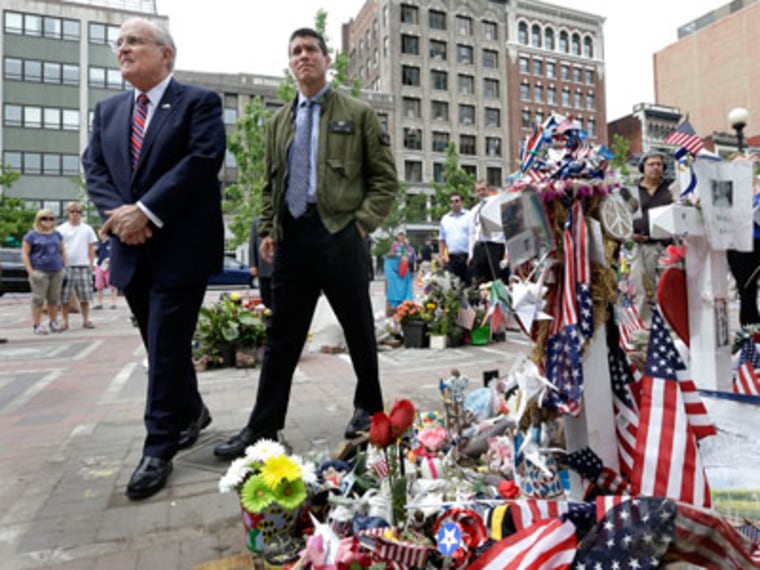 Former New York City Mayor Rudy Giuliani and Gabriel Gomez, the Republican candidate for U.S. Senate in the Massachusetts special election, view the makeshift memorial at Copley Square in Boston on June 6, 2013. (Photo by Elise Amendola/AP)