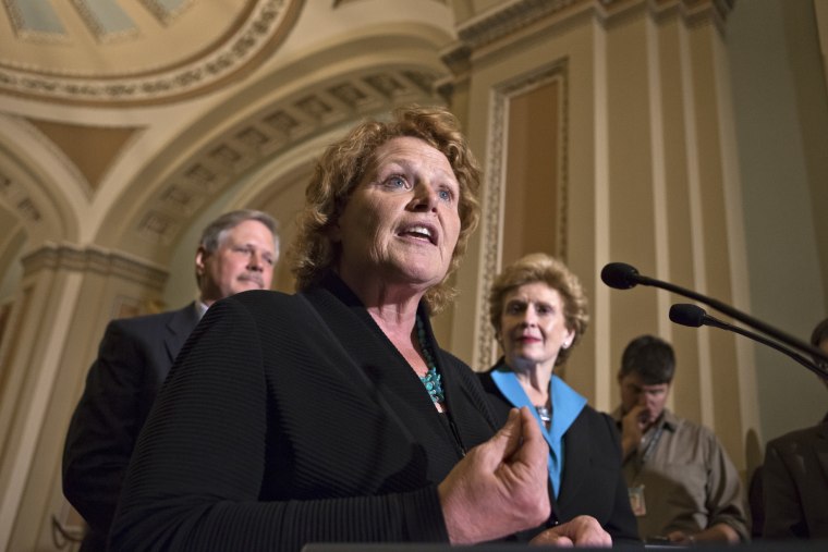 Sen. Heidi Heitkamp, D-N.D., center, joins Sen. Debbie Stabenow, D-Mich., chairwoman of the Senate Agriculture Committee, right, and Sen. John Hoeven, R-ND, left, to speak to reporters as the Senate votes on a farm bill that sets policy for farm...
