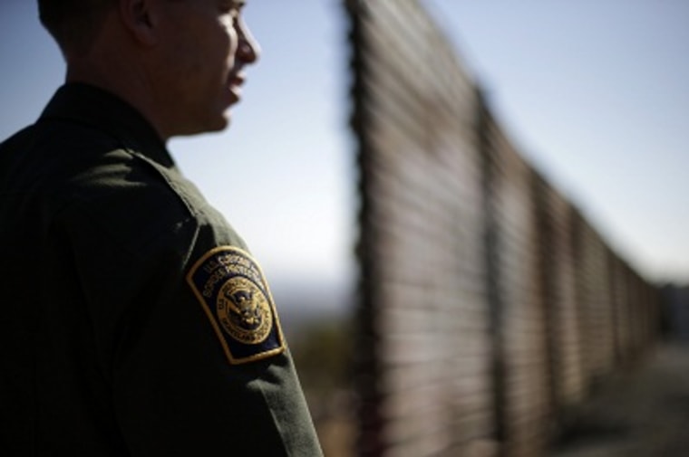In this June 13, 2013 picture, U.S. Border Patrol agent Jerry Conlin looks to the north near where the border wall ends as is separates Tijuana, Mexico and San Diego. (Photo by Gregory Bull/AP)