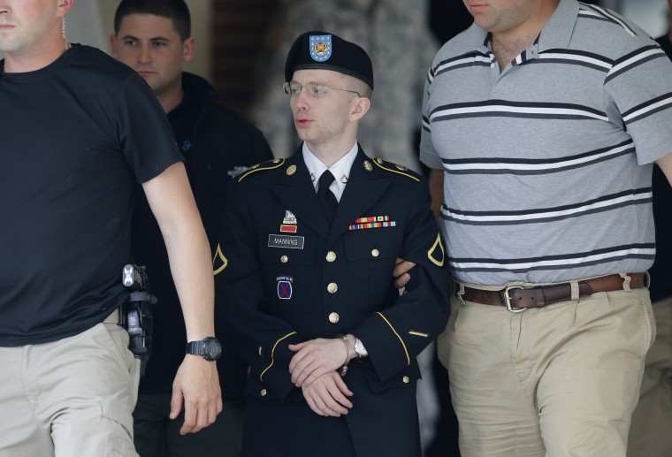 Army Pfc. Bradley Manning, center, is escorted out of a courthouse in Fort Meade, Md., Monday, June 17, 2013, after the start of the third week of his court martial. (AP Photo/Patrick Semansky)