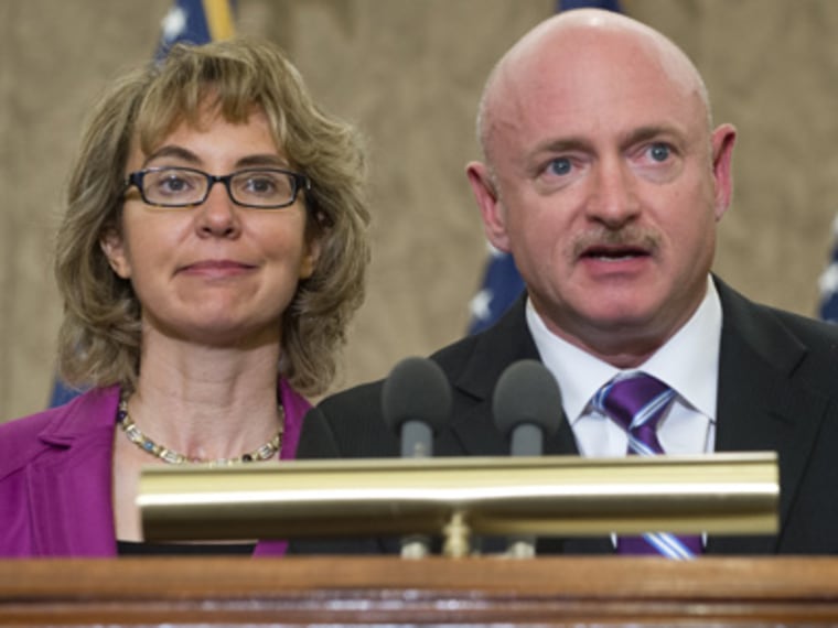 Former Arizona Representative Gabrielle Giffords and her husband Mark Kelly attend a dedication ceremony naming a Capitol Visitor Center conference room in honor of slain Giffords' aide Gabe Zimmerman at the US Capitol in Washington on April 16, 2013. ...