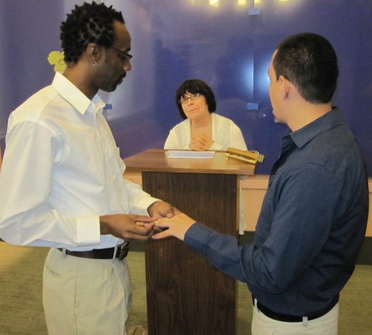 Sean and Steven Brooks exchanging rings on the day of the wedding in City Hall in New York City. (Photo credit: The DOMA Project)