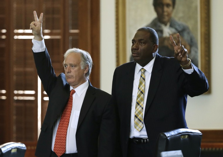 Sen. Kirk Watson, left, D-Austin, and Sen. Royce West, right, D-Dallas, vote against actions that would begin the debate early on legislation sent over by the house, Monday, June 24, 2013, in Austin, Texas. The Republican-dominated Texas Legislature...