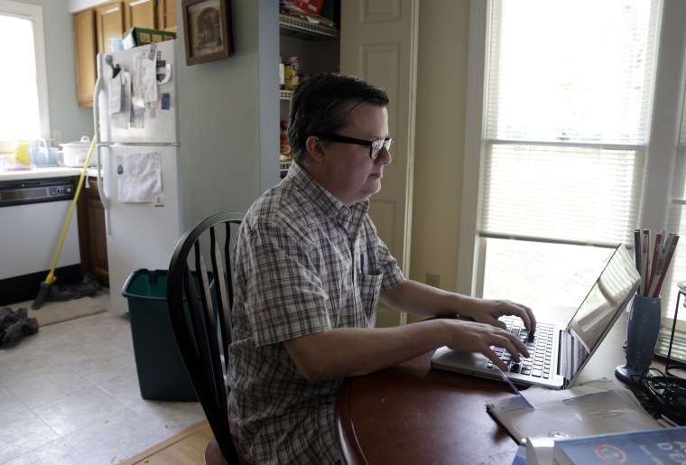 Lee Creighton looks for jobs on the Internet at his home in Cary, N.C., Thursday, June 27, 2013. Creighton has been unemployed since October and will receive his last bit of unemployment aid this week. (Photo by Gerry Broome/AP)
