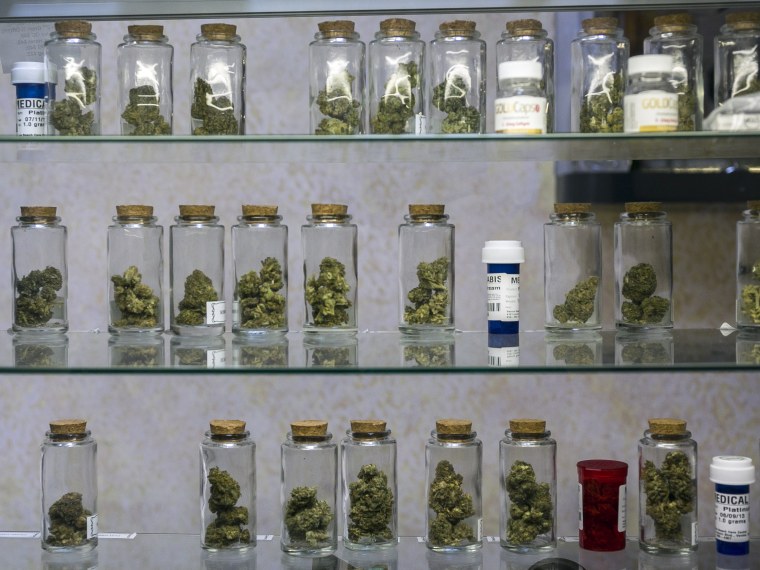In this photo taken Tuesday, May 14, 2013, Medical marijuana vials are displayed at the Venice Beach Care Center medical marijuana dispensary in Venice, Calif.  (AP Photo/Damian Dovarganes)