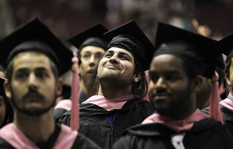A graduate smiles as he takes his seat at the Berklee College of Music Commencement in Boston, Massachusetts May 12, 2012. (Photo by Jessica Rinaldi/Reuters)