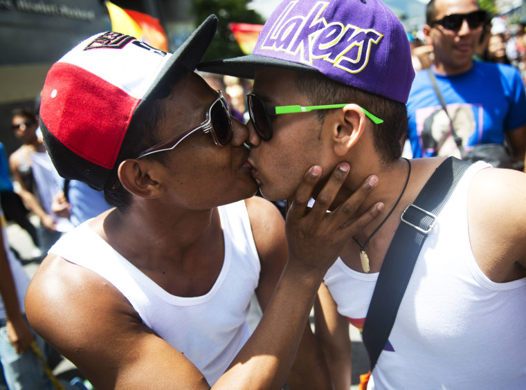 Two men kiss during the 35th Gay Pride Parade in downtown Caracas on June 30, 2013.  (Photo by Leo Ramirez/AFP/Getty Images)