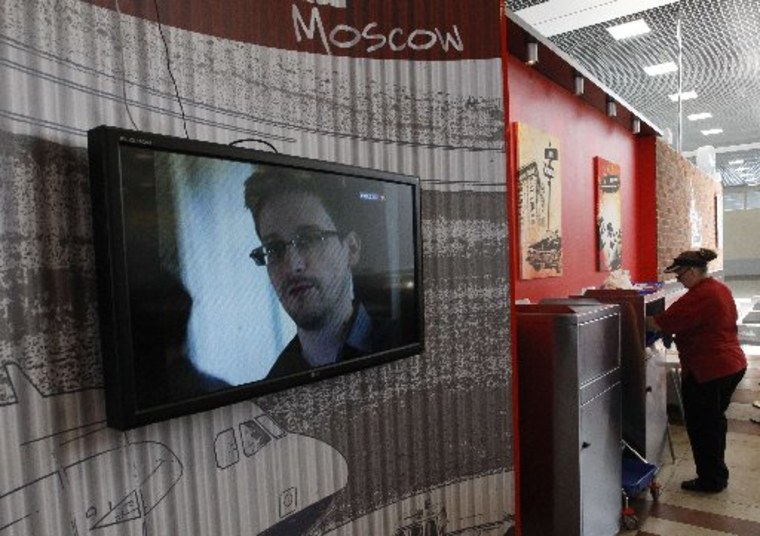 A television screens the image of former U.S. spy agency contractor Edward Snowden during a news bulletin at a cafe at Moscow's Sheremetyevo airport June 26, 2013. Russian President Vladimir Putin confirmed on Tuesday that Snowden, sought by the United...