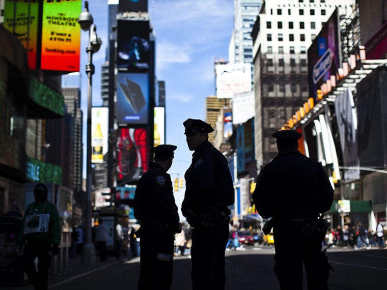 New York Police officers keep watch on tourists at Times Square in New York April 21, 2013. (Photo by Eduardo Munoz/Reuters)