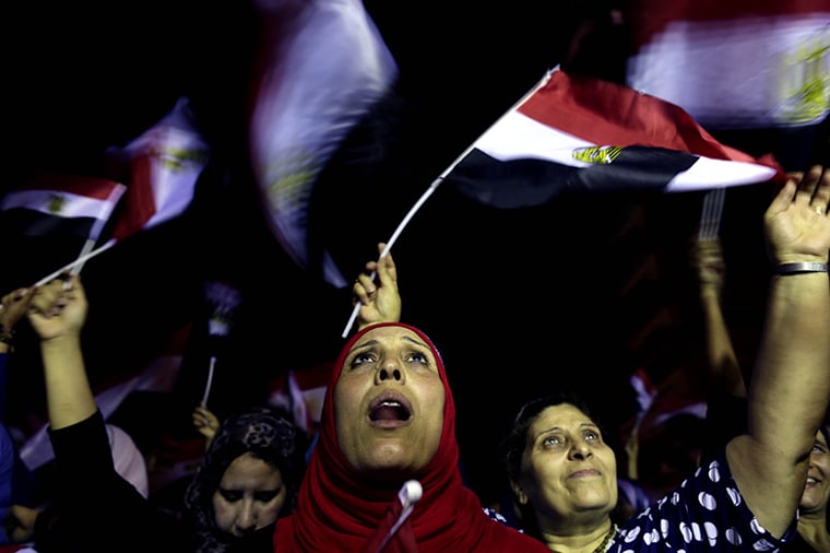 Opponents of Egypt's Islamist leader Mohammed Morsi celebrate outside the presidential palace in Cairo, Egypt, Wednesday, July 3, 2013. A statement on the Egyptian president's office's Twitter account has quoted Mohammed Morsi as calling military...