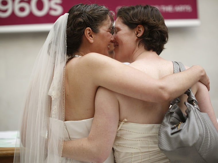 Same-sex couple Cynthia Wides (L) and Elizabeth Carey embrace each other as they turn in their marriage license at City Hall in San Francisco, June 29, 2013. (Photo by Stephen Lam/Reuters)