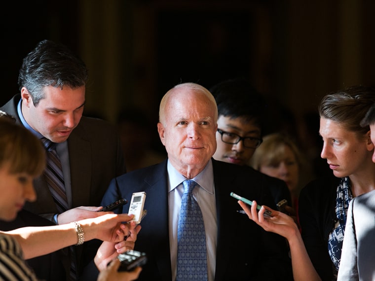 Sen. John McCain (R-AZ) talks with reporters as he walks to a Senate joint caucus meeting, on Capitol Hill, July 15, 2013 in Washington, DC.  (Photo by Drew Angerer/Getty Images)