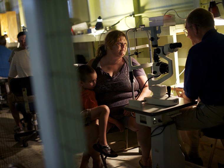 A patient has an eye exam at the Remote Area Medical (RAM) clinic in Wise, Virginia July 20, 2012.  RAM clinics bring free medical, dental and vision care to uninsured and under-insured people across the country and abroad.   (Photo by Mark Makela/AP)