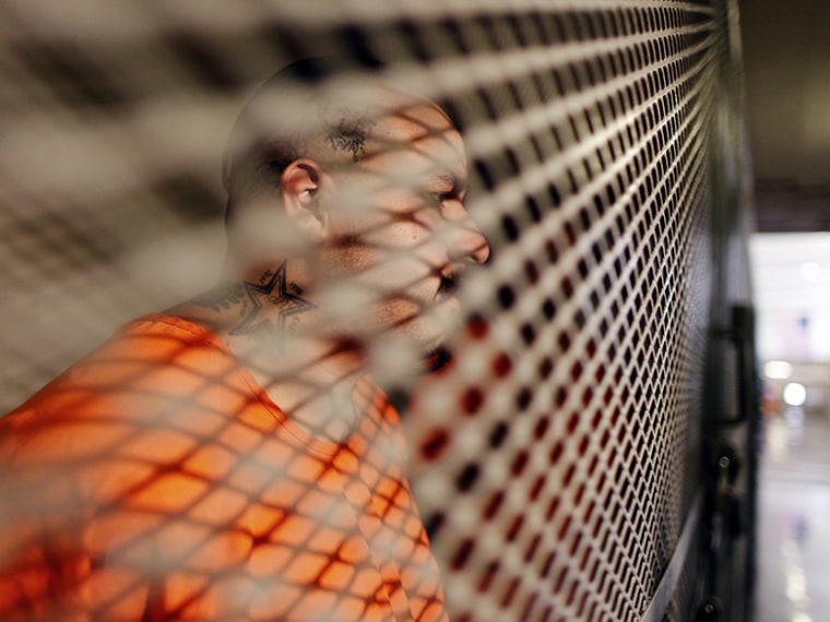 Inmate Bobby Cortez, 29, sits in a cage at the California Institution for Men state prison in Chino, California, June 3, 2011.  (Photo by Lucy Nicholson/Reuters)