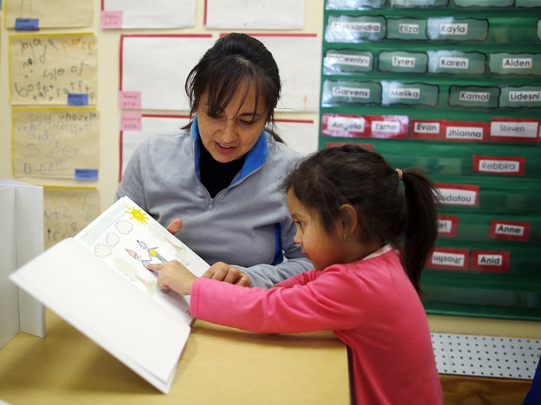 Paola Garcia reads a book with her three-year-old daughter Emily at Action for Boston Community Development's (ABCD) Head Start program in the Roslindale neighborhood of Boston, Massachusetts March 5, 2013. According to ABCD, 95 percent of the money...