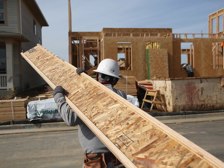 A laborer works at a housing development on May 3, 2013, in Denver, Colo.  (Photo by John Moore/Getty Images)