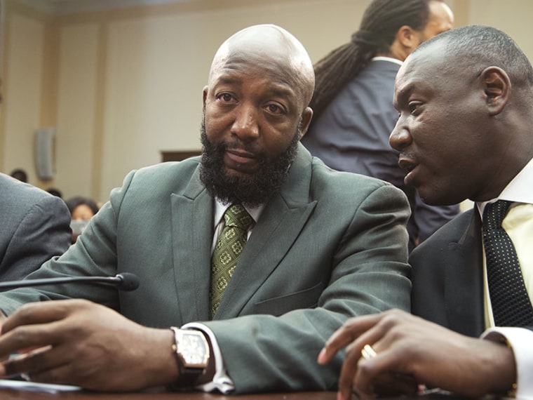 Tracy Martin, father of Trayvon Martin, left, talks to his attorney Benjamin Crump, on Capitol Hill in Washington, Wednesday, July 24, 2013, during a forum entitled \"The Status of Black Males: Ensuring Our Boys Mature Into Strong Men.\"   (Photo by...
