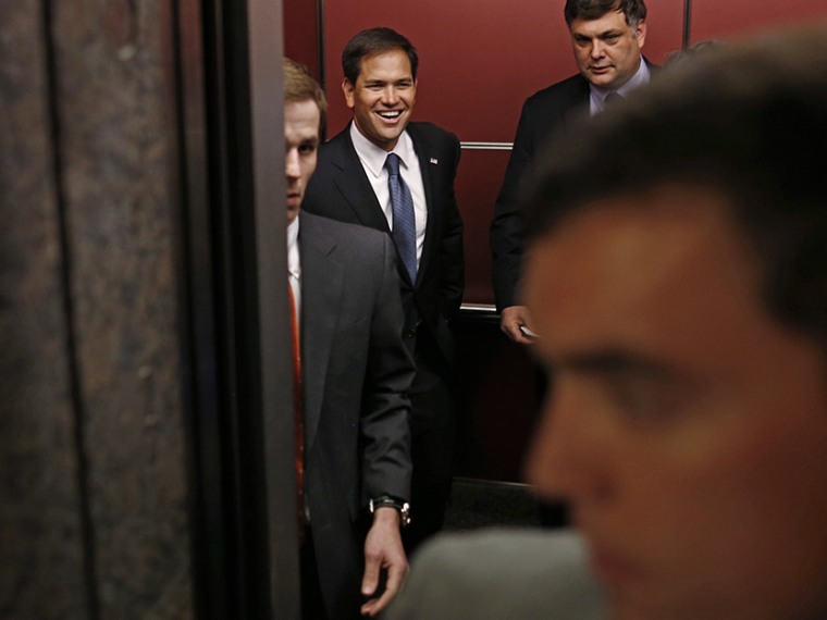 Sen. Marco Rubio, R-Fla. center, smiles from inside an elevator as he leaves reporters who were following him behind after he spoke at the Faith and Freedom Coalition Road to Majority Conference in Washington, Thursday, June 13, 2013. (Photo by Charles...