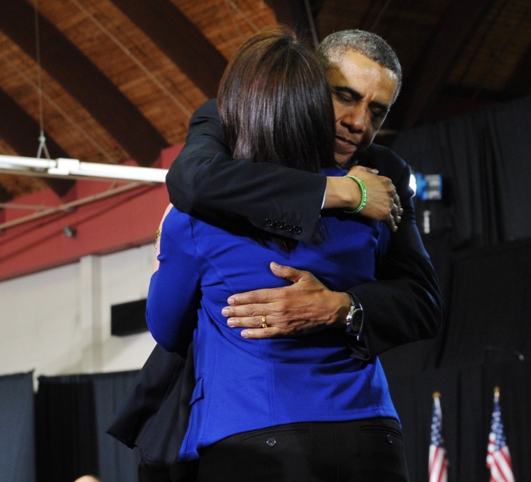 US President Barack Obama hugs Nicole Hockley as her husband Ian Hockley (R) looks on after they introduced Obama as he arrives to speak on gun control on April 8, 2013 at the University of Hartford, in Hartford, Connecticut. The Hockley's son was...