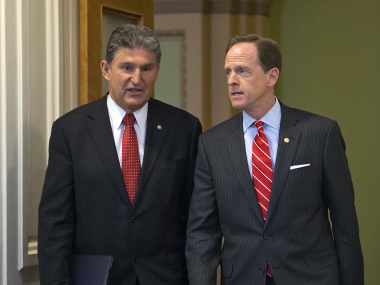 Sen. Joe Manchin of West Virginia, D-W.Va., left, and Sen. Patrick Toomey, R-Pa., arrive at a news conference on Capitol Hill in Washington, Wednesday, April 10, 2013, to announce that they have reached a bipartisan deal on expanding background checks...