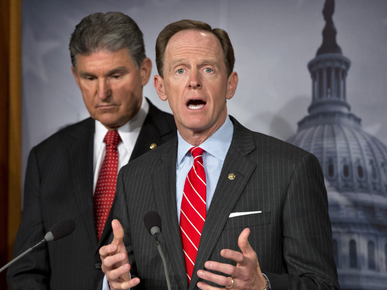 Sen. Joe Manchin, D-W.Va. listens at left, as Sen. Patrick Toomey, R-Pa. announce that they have reached a bipartisan deal on expanding background checks to more gun buyers, Wednesday, April 10, 2013, on Capitol Hill in Washington.  (Photo by J. Scott...
