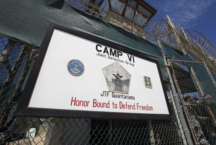 A guard opens the gate at the entrance to Camp VI, a prison used to house detainees at the U.S. Naval Base at Guantanamo Bay in this file photo taken March 5, 2013. Pretrial hearings in the Guantanamo war crimes tribunals have been delayed to address...