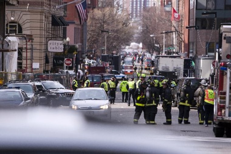 Boston Police and Firemen stand by at the scene after explosions interrupted the running of the 117th Boston Marathon in Boston, Massachusetts April 15, 2013. (Photo by Dominick Reuter/Reuters)