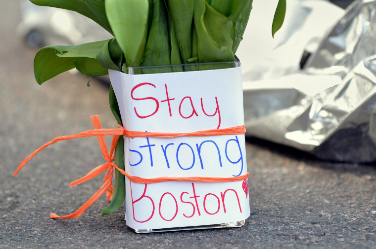 Flowers and a message are left on Newbury Street April 16, 2013 in Boston, Massachusetts, a few blocks from where two explosions struck near the finish line of the Boston Marathon on Monday. Three people, including a child, were killed and more than...