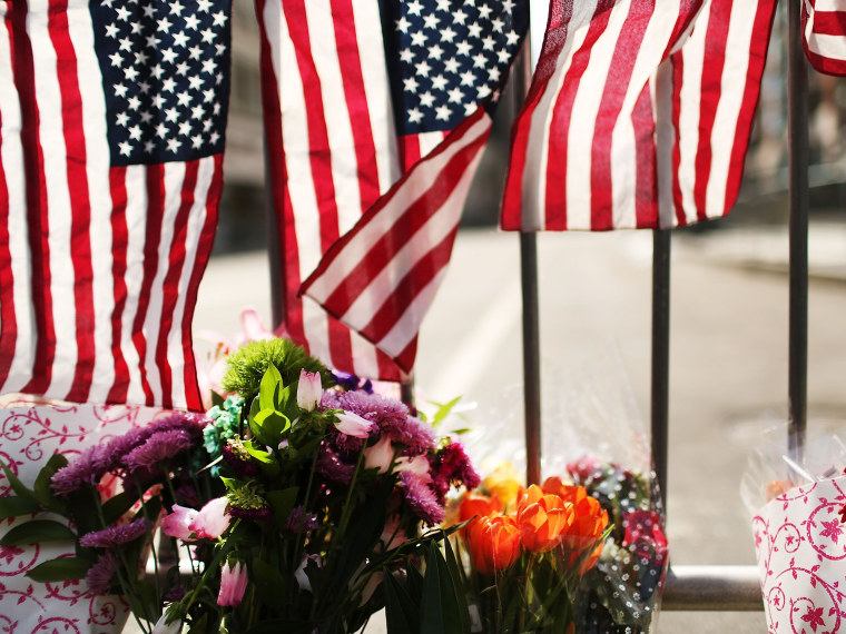 Flowers are left at a security gate near the scene of yesterday's bombing attack at the Boston Marathon on April 16, 2013 in Boston, Massachusetts. (Photo by Spencer Platt/Getty Images)