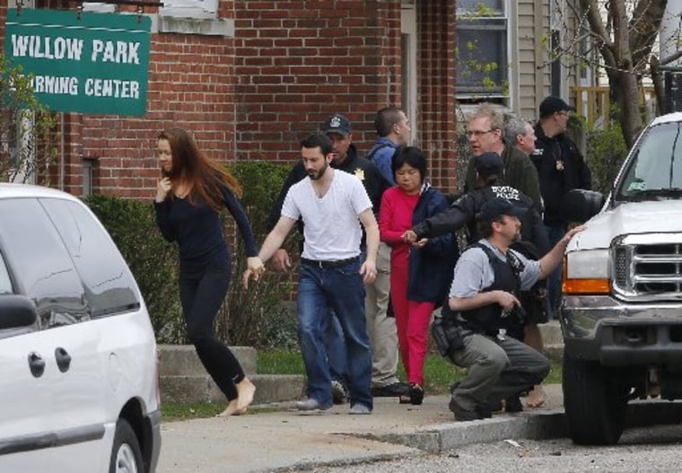 Residents are evacuated as FBI agents search homes for the Boston Marathon bombing suspects in Watertown, Massachusetts April 19, 2013. (Photo by Reuters/Brian Snyder)
