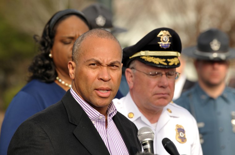 Massachusetts Governor Deval Patrick (L) speaks to the media at a shopping mall on the perimeter of a locked down area as a search for the second of two suspects wanted in the Boston Marathon bombings took place April 19, 2013, in Watertown, Mass. ...