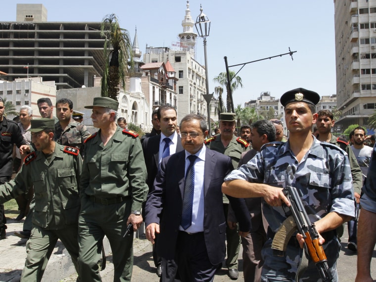 Syrian Interior Minister Mohammed al-Shaar (C) visits the site of a blast in the Marjeh district of Damascus on April 30 , 2013. A blast in the central Damascus district of Marjeh killed at least 14 people, Syrian state television reported, a day after...